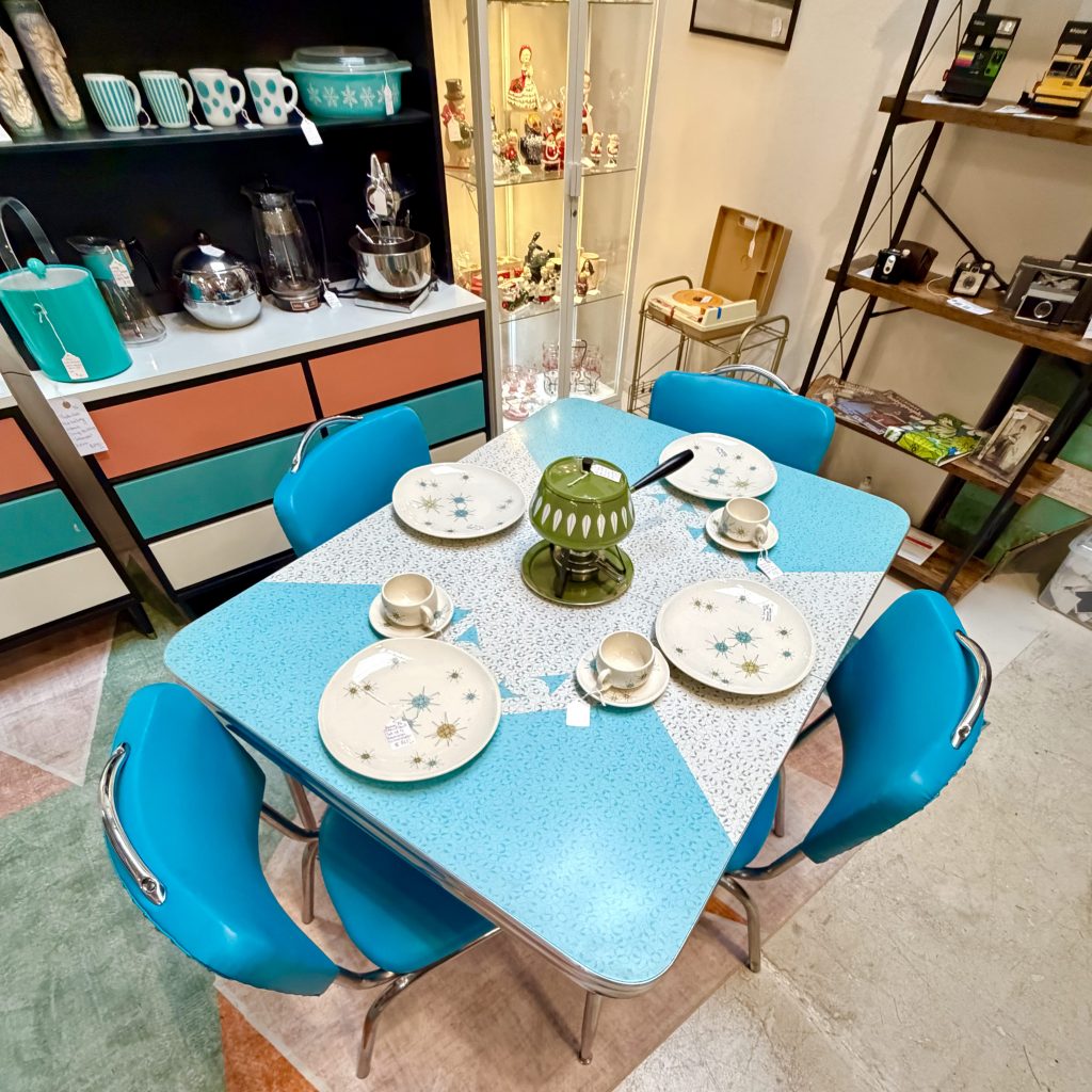 Authentic turquoise mid-century Formica table set with atomic starburst decor and vintage dishware